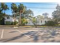 Street view of a white house with green roof and adjacent garage at 106 Banana St, Tarpon Springs, FL 34689