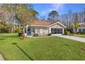 Single-story house with a large green lawn at 11830 Wax Myrtle Ct, New Port Richey, FL 34654