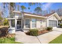 House exterior with a screened porch and walkway at 11830 Wax Myrtle Ct, New Port Richey, FL 34654