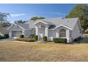 Single-story house with gray exterior, landscaping, and a large yard at 13429 Lawrence St, Spring Hill, FL 34609