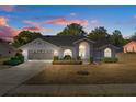Gray house with an arched entryway, and nicely landscaped yard at 13429 Lawrence St, Spring Hill, FL 34609