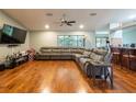 Spacious living room featuring hardwood floors and a large sectional sofa at 1378 Haulover Ave, Spring Hill, FL 34608