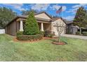 Charming one-story house with manicured lawn and American flag at 15439 Stone House Dr, Brooksville, FL 34604