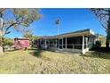 Backyard with screened patio and shed at 1624 Sea Breeze Dr, Tarpon Springs, FL 34689