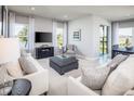 Spacious living room with a cozy seating area and large windows at 2463 White Ladyfish Rd, Wimauma, FL 33598