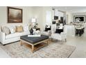 Open concept living room and kitchen with neutral colors and stylish decor at 2467 White Ladyfish Rd, Wimauma, FL 33598