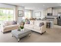 Open concept living room and kitchen with island and seating at 2473 White Ladyfish Rd, Wimauma, FL 33598