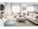 Spacious living room with large windows and comfortable seating at 2473 White Ladyfish Rd, Wimauma, FL 33598