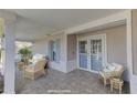 Inviting front porch with wicker furniture, creating a relaxing space at 4710 Parkdale Ln, New Port Richey, FL 34655