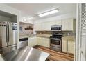 Well-equipped kitchen with stainless steel appliances and granite countertops at 5557 Sea Forest Dr # 117, New Port Richey, FL 34652