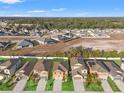 Aerial view showcasing a community of houses with green lawns at 578 Argyll Dr, Spring Hill, FL 34609
