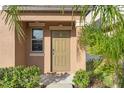 Inviting front door entrance with landscaping and a small porch at 578 Argyll Dr, Spring Hill, FL 34609