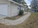 Curved sidewalk leading to the side entrance of the home at 7538 Bougenville Dr, Port Richey, FL 34668
