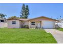 Charming single-story home with well-manicured lawn and attached one car garage at 13531 Allyn Dr, Hudson, FL 34667