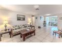 Open living room featuring tile floors, neutral walls, and comfortable seating area at 13531 Allyn Dr, Hudson, FL 34667