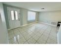 Bright and spacious living room with tile floors at 1415 Weyford Ln, Holiday, FL 34691