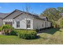 A single-story house boasts tidy landscaping, neutral stucco, and well-maintained lawn at 16723 Shell Bay Dr, Land O Lakes, FL 34638