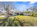 House exterior featuring a large yard and solar panels at 18104 Spencer Rd, Odessa, FL 33556