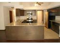 L-shaped kitchen with granite countertops and stainless steel appliances at 18623 Firethorn Dr, Spring Hill, FL 34610