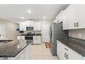 Modern kitchen with white cabinets and granite countertops at 194 Argyll Dr, Spring Hill, FL 34609