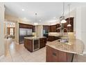 Spacious kitchen boasts an island, granite counters, and stainless steel appliances at 20200 Lace Cascade Rd, Land O Lakes, FL 34637