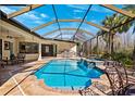 Inviting screened pool area with outdoor kitchen and seating at 20200 Lace Cascade Rd, Land O Lakes, FL 34637