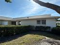 Exterior view showcasing the well-maintained home with manicured landscaping and a tidy yard at 2718 Highlands Blvd # A, Palm Harbor, FL 34684