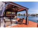 Relaxing waterfront gazebo with comfortable wicker furniture at 3308 Oleander Dr, Hernando Beach, FL 34607