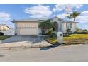 Single-story house with a large driveway and mature trees at 3912 Rudder Way, New Port Richey, FL 34652
