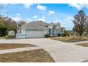 Front view of a single-story home with a white exterior and teal accents at 4438 Crescent Rd, Spring Hill, FL 34606