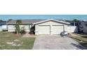 Front view of a single-story house with a two-car garage at 4949 Waterside Dr, Port Richey, FL 34668