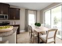 Kitchen with a breakfast nook and access to a back patio at 6021 Wild Petunia Dr, Wimauma, FL 33598