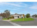 Well-maintained home on a corner lot with a lush green lawn and a convenient two-car garage at 6520 Pine Meadows Dr, Spring Hill, FL 34606
