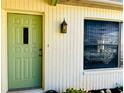 Charming light green front door with a window inset at 7240 Dogleg Ct, Port Richey, FL 34668