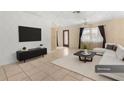 Living room with sectional sofa, TV, and coffee table at 7464 Acorn Cir, Spring Hill, FL 34606