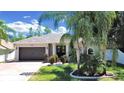 House exterior showcasing a two-car garage and manicured lawn at 807 Virginia Ave, Tarpon Springs, FL 34689