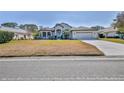 One-story home with a large front yard at 9694 Southern Belle Dr, Weeki Wachee, FL 34613
