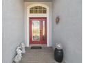 Inviting entryway with decorative glass door, brickwork, and charming decor at 11637 Spindrift Loop, Hudson, FL 34667