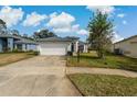 Traditional style home with a two car garage and concrete driveway at 11744 Wheatfield Loop, Hudson, FL 34667