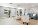 Bright living room with neutral walls, a ceiling fan, and stylish furniture creating an inviting and comfortable space at 1310 Georgia Ave, Dunedin, FL 34698