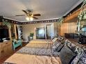 Spacious bedroom with a large bed, ceiling fan, warm lighting, and closet access at 30 Turner St # 208, Clearwater, FL 33756