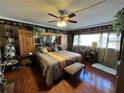 This bedroom features a large bed with unique animal print bedding, ceiling fan, and natural light at 30 Turner St # 208, Clearwater, FL 33756