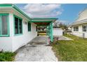 Covered carport area with view of the backyard and neighboring houses at 5648 Riverview Dr, New Port Richey, FL 34652