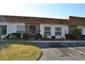 Front view of a condo building showcasing its neat landscaping and parking area at 6124 Chesham Dr # 6, New Port Richey, FL 34653