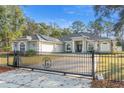 Charming single story home featuring a gated driveway and a well-manicured lawn at 7482 Winter St, Brooksville, FL 34613