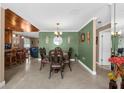 Bright dining room with a wood table and green walls at 7489 Gates Cir, Spring Hill, FL 34606