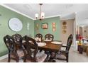 Dining room featuring a dark wood table and six chairs at 7489 Gates Cir, Spring Hill, FL 34606