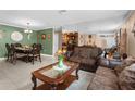 Spacious living room featuring a dining set and a brown leather couch at 7489 Gates Cir, Spring Hill, FL 34606