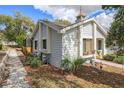 Home exterior showcasing siding, roof, landscaping, and screened in porch in a backyard setting at 8194 Sturbridge Ct # A, Weeki Wachee, FL 34613