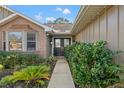 Welcoming walkway leading to a double-door entry with decorative glass at 8434 Hazelton St, Spring Hill, FL 34608